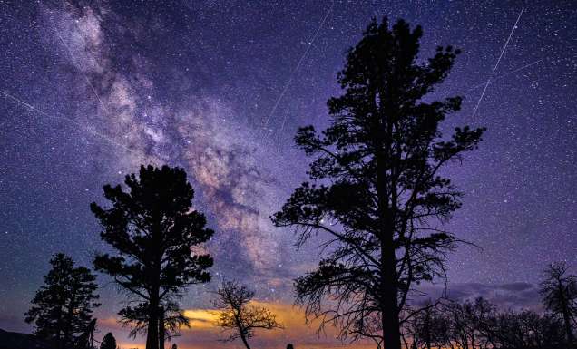 Lyrid Meteor Shower - Night astrophotography skies with light trails from streaking meteors in April.