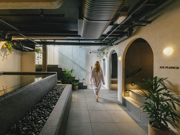 Woman walking through Navia Bathhouse in Byron Bay