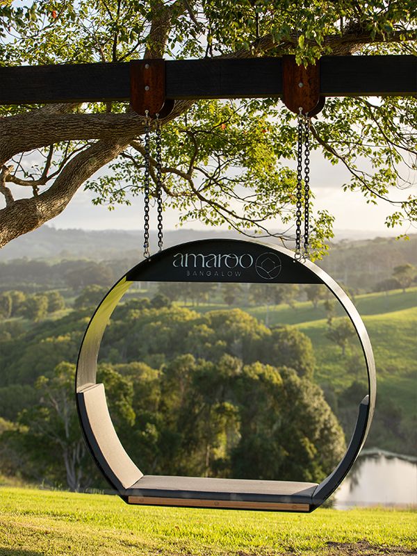 A swing overlooking hinterland views at Amaroo Bangalow.