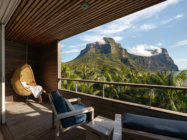 a woman relaxing in a hammock on the balcony of Capella Lodge, Lord Howe Island
