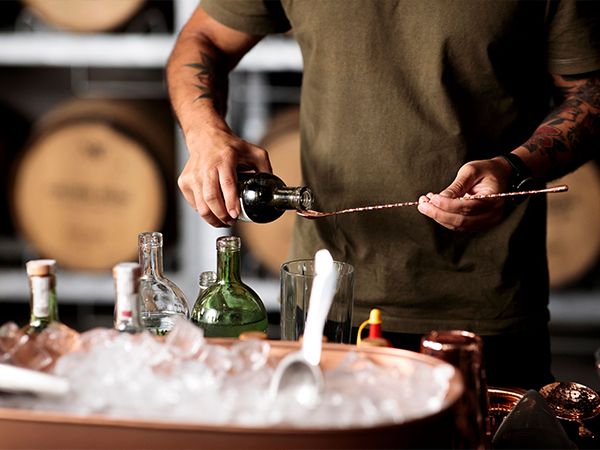 A man pouring a gin cocktail.