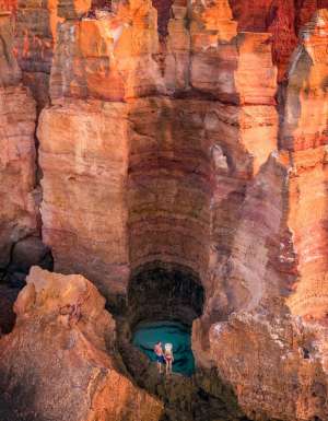 A couple stands over a waterhole in the Dampier Peninsula WA