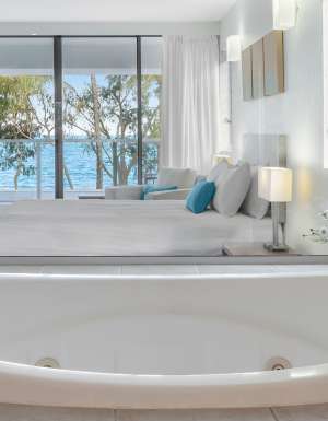 a spa tub with ocean views at Drift Palm Cove