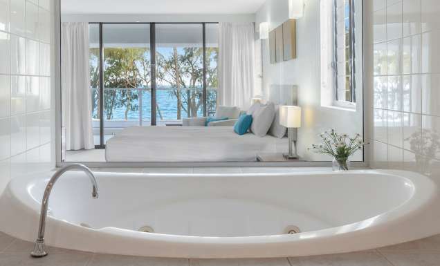 a spa tub with ocean views at Drift Palm Cove