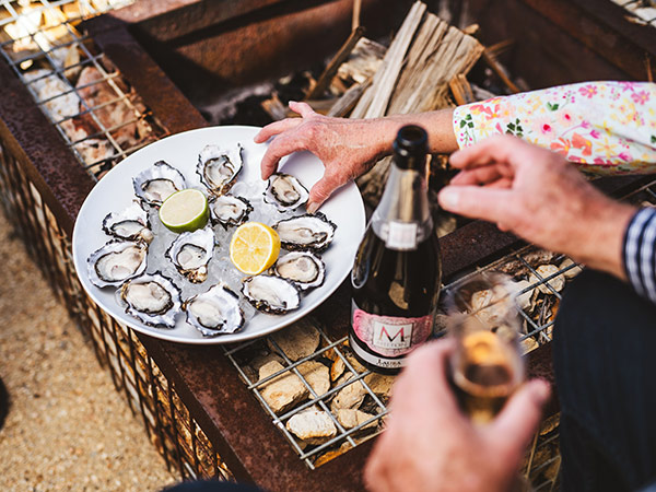 people eating oysters at Swansea Beach Chalets in tasmania