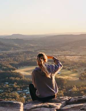 woman enjoying the view after hiking through Noosa National Park, noosa in winter
