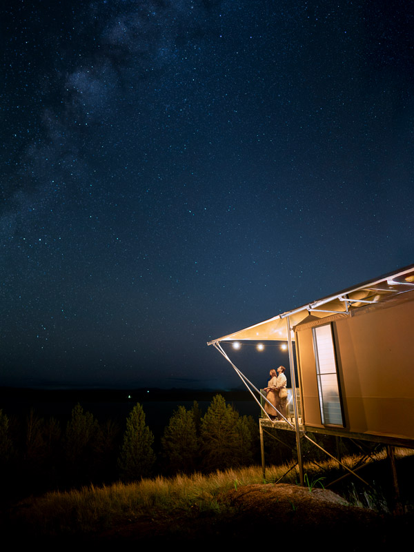 Couple stargazing on deck at Wilderluxe glampsite at Lake Keepit