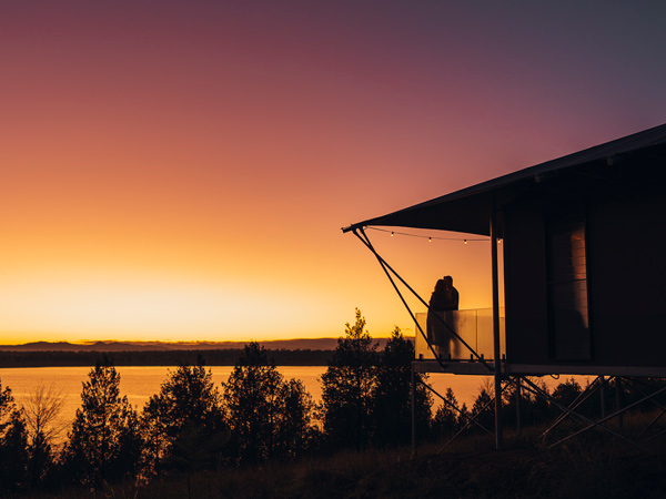 Couple enjoy a sunrise over Lake Keepit at Wilderluxe