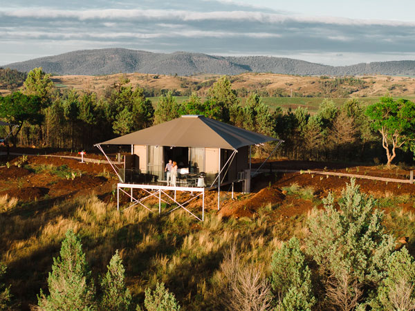 Couple on deck at Wilderluxe glamping site in Lake Keepit