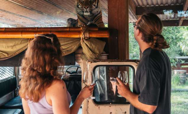a couple holding wine on the Taronga Zoo wine safari sydney