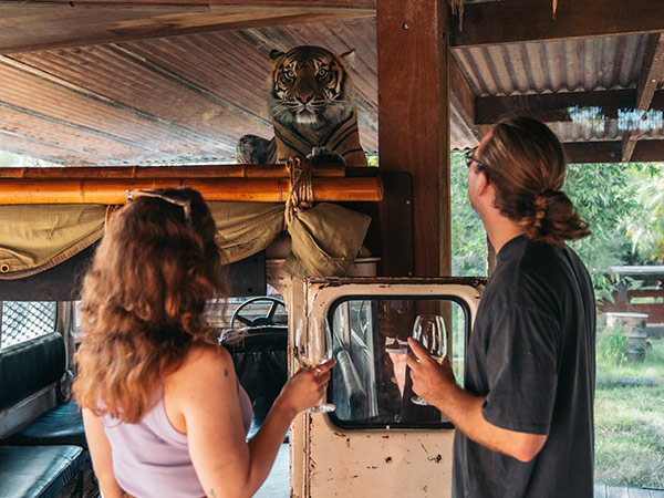 a couple holding wine on the Taronga Zoo wine safari sydney