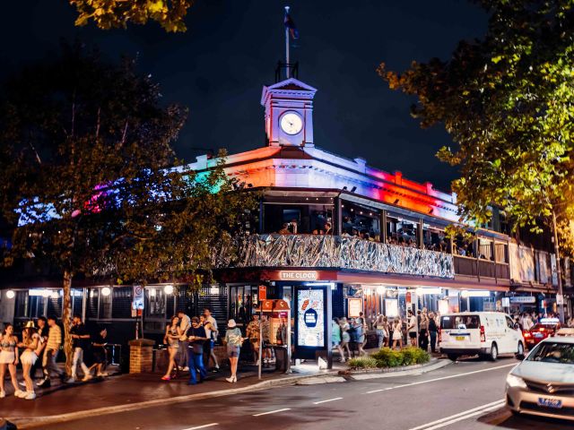 the two-storey The Clock pub at night