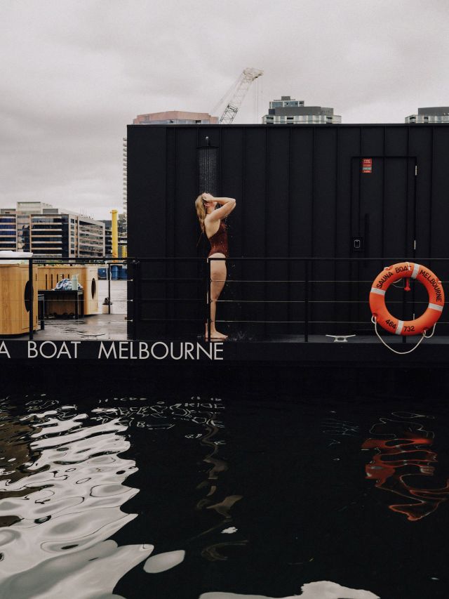 woman under cold shower on sauna boat melbourne