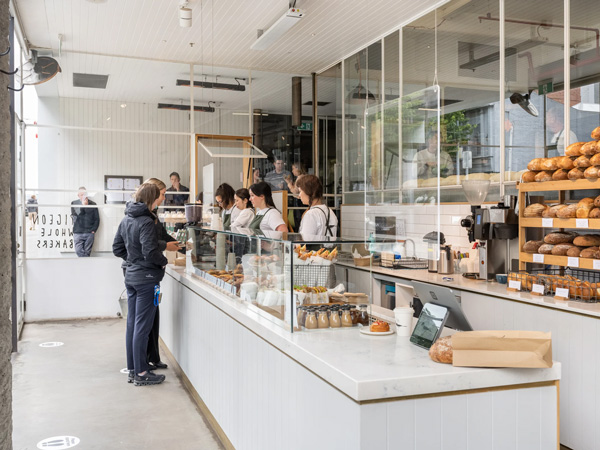 a customer ordering bread at Pigeon Whole Bakers, Hobart cafe