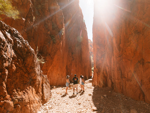 a group exploring Standley Chasm on a cultural tour