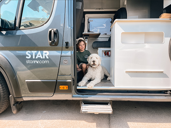 A child and its pet inside Star RV Motorhomes.