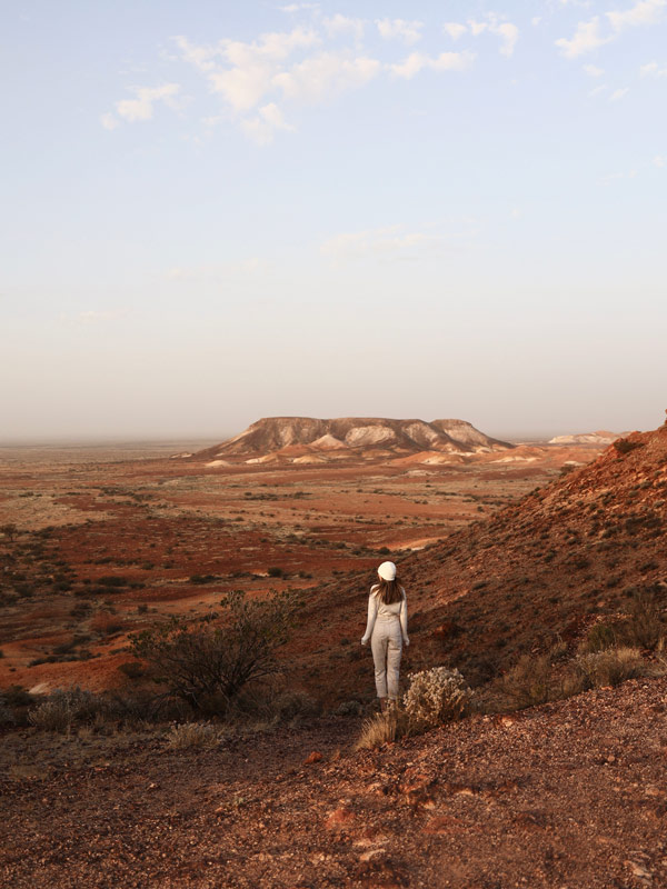 a woman exploring the hills of Kanku-Breakaways Conservation Park