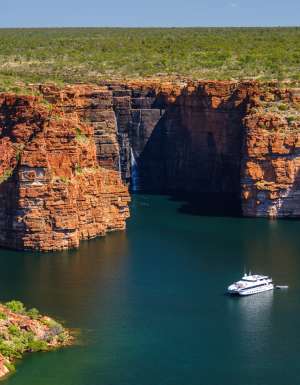 A Kimberley cruise drifts beneath King George Falls, where sheer sandstone cliffs frame the thunderous plunge into turquoise waters. Discover the best of Australia's North West cruises.