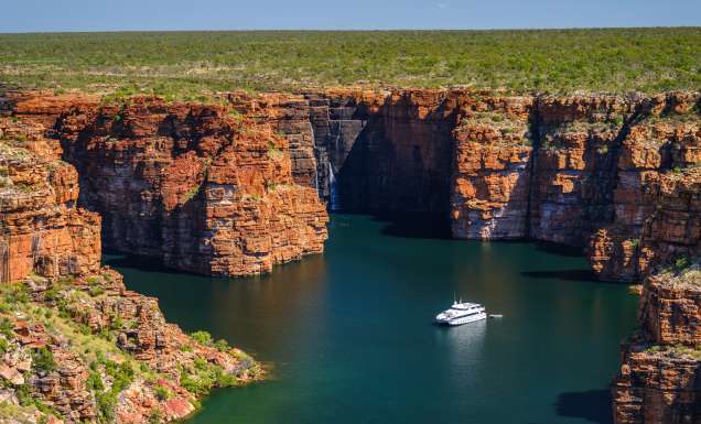 A Kimberley cruise drifts beneath King George Falls, where sheer sandstone cliffs frame the thunderous plunge into turquoise waters. Discover the best of Australia's North West cruises.