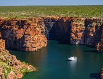 A Kimberley cruise drifts beneath King George Falls, where sheer sandstone cliffs frame the thunderous plunge into turquoise waters. Discover the best of Australia's North West cruises.
