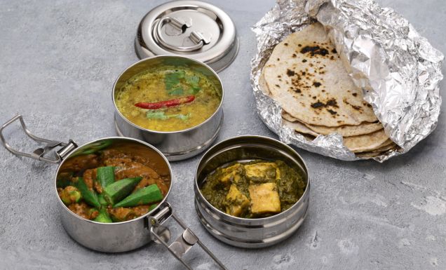 A retro Indian tiffin lunch box filled with vegetarian food. And chapati.