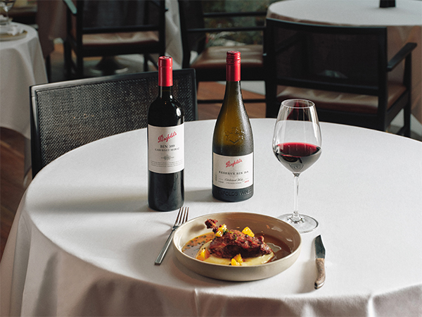 A glass of wine paired with Penfolds on a tablecloth-clad table at ritzy brasserie Glass 