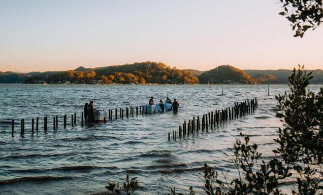 People wading in the water at Sydney Rock Oysters in-water dining experience