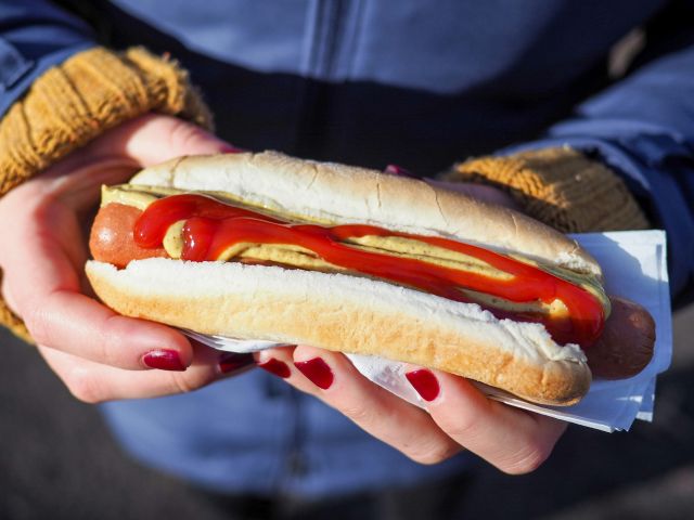 woman holding a hot dog