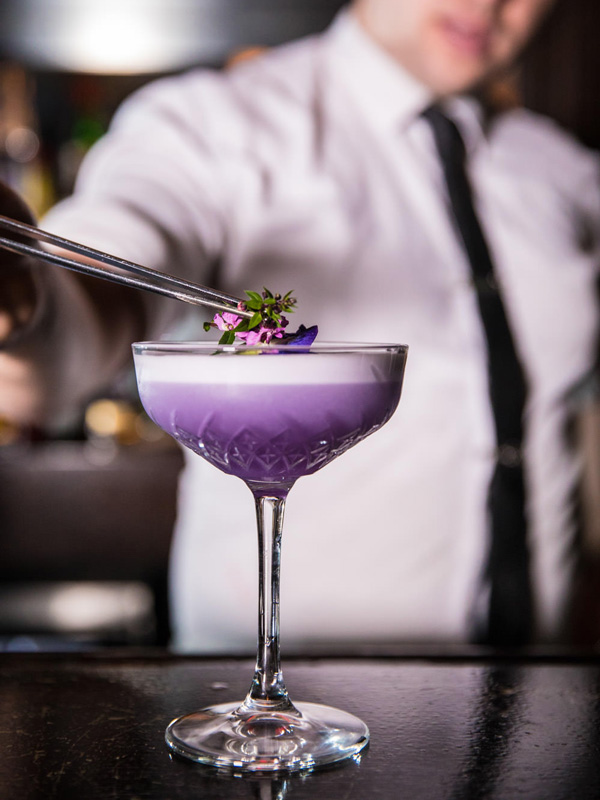 a bartender adding toppings on a drink at Jimmy Rums, Port Douglas bars and pubs