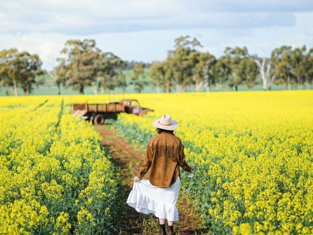 woman walking on path through Cornella Canola Walk