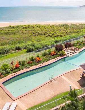 A resort swimming pool with views to the ocean