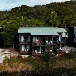 kassia standing on resort room balcony at kingfisher bay resort on k'gari