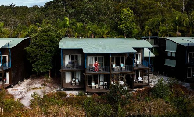 kassia standing on resort room balcony at kingfisher bay resort on k'gari