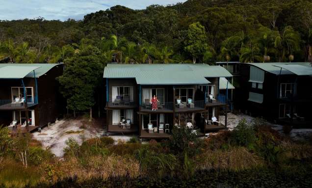kassia standing on resort room balcony at kingfisher bay resort on k'gari