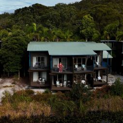 kassia standing on resort room balcony at kingfisher bay resort on k'gari