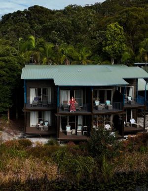 kassia standing on resort room balcony at kingfisher bay resort on k'gari