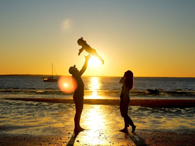 a family enjoying the sunset in front of kingfisher bay resort on k'gar fraser island