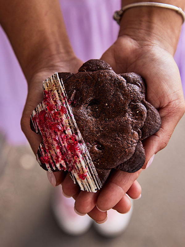 creator holding Mrs Browne Bakes’ raspberry goldfields cookie pie at Naomi & i