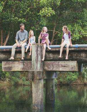 A family sitting by the Orara Valley Tourist Trail