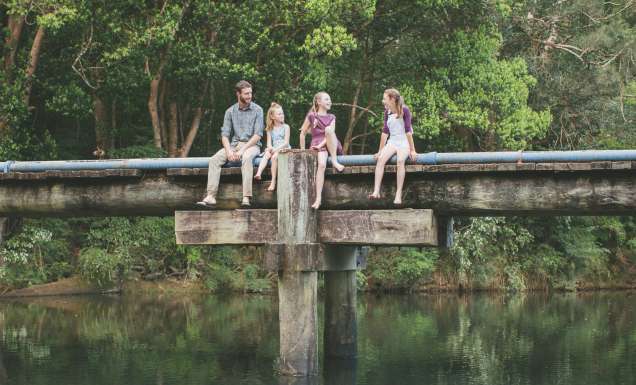 A family sitting by the Orara Valley Tourist Trail