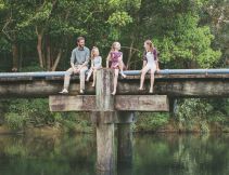 A family sitting by the Orara Valley Tourist Trail