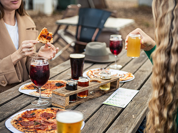 table spread of pizza, wine and beer at shiraz rebulic
