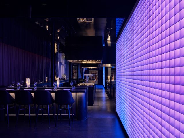 the bright purple wall-mounted video panels at Garaku