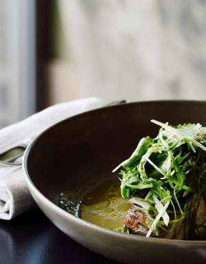 A dish with fish and greens.