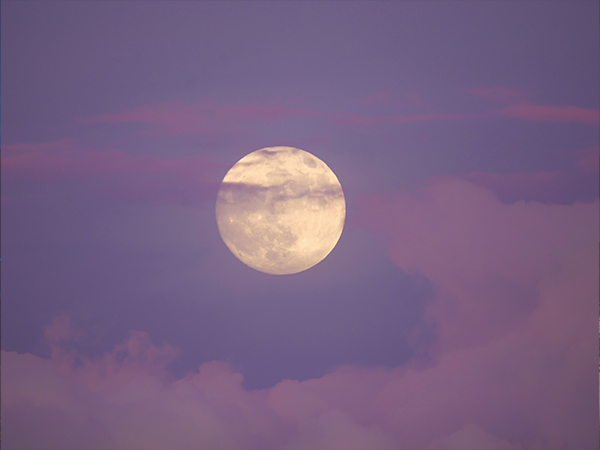 A full moon during sunset
