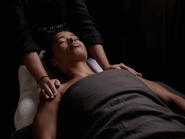 a woman enjoying a relaxing spa treatment at The Bower Byron Bay