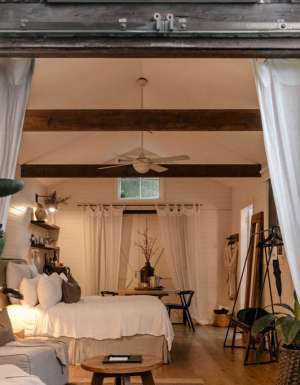 A white barn studio accommodation with barns doors open