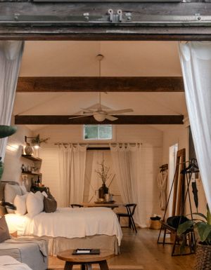 A white barn studio accommodation with barns doors open