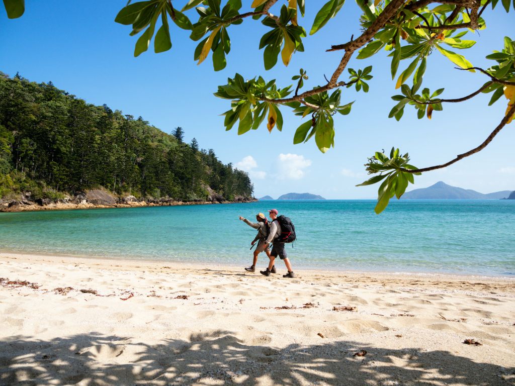 Hikers on the beach of The Ngaro Track, Whitsunday Islands