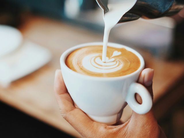 Coffee being poured with latte art